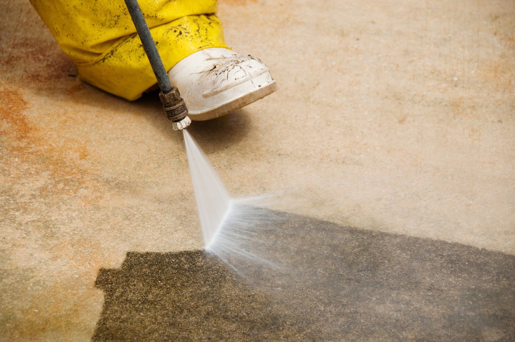 Professional pressure washing a driveway